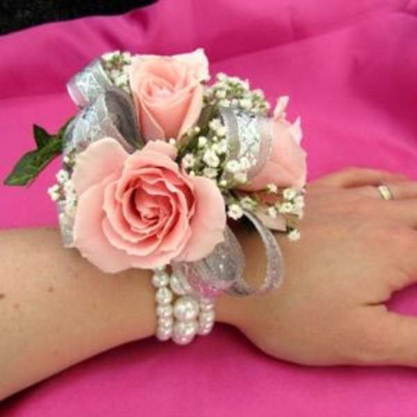 Pink rose wrist corsage with silver ribbon and pearl bracelet