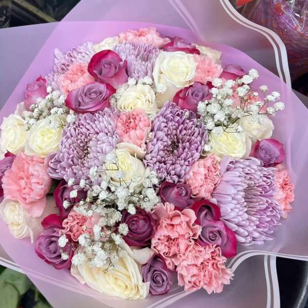Bouquet of pink, lavender, and white roses with chrysanthemums and baby's breath