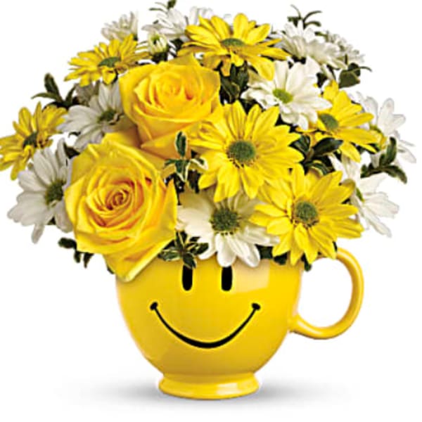 Yellow roses and daisies in a yellow smiley-face mug