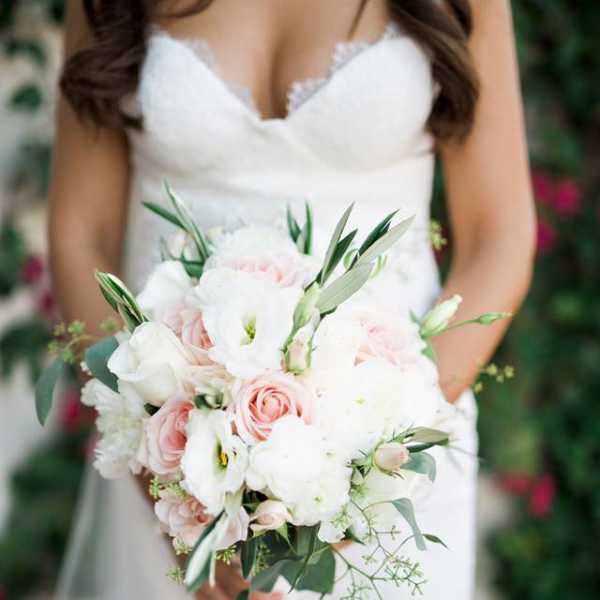 Bride holding a white and blush bouquet