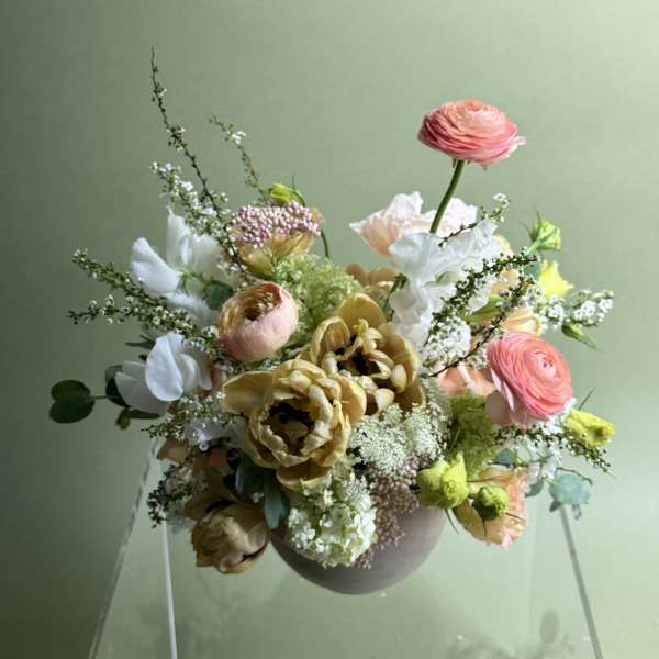 Mixed bouquet in a round vase with pink, white, and yellow blooms