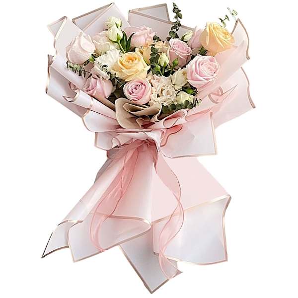 Bouquet of pastel roses wrapped in pink ribbon