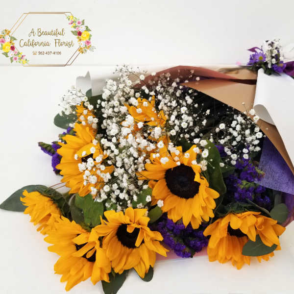 Bouquet of yellow sunflowers with white baby's breath and purple filler flowers