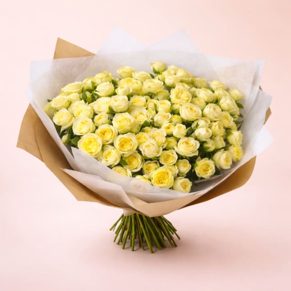 Bouquet of pale yellow roses wrapped in white and brown paper