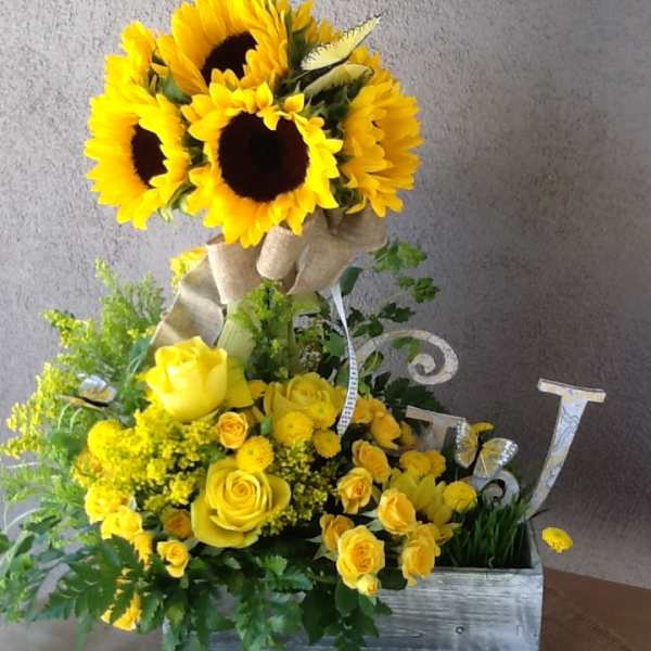 Yellow sunflower and rose arrangement in a wooden box