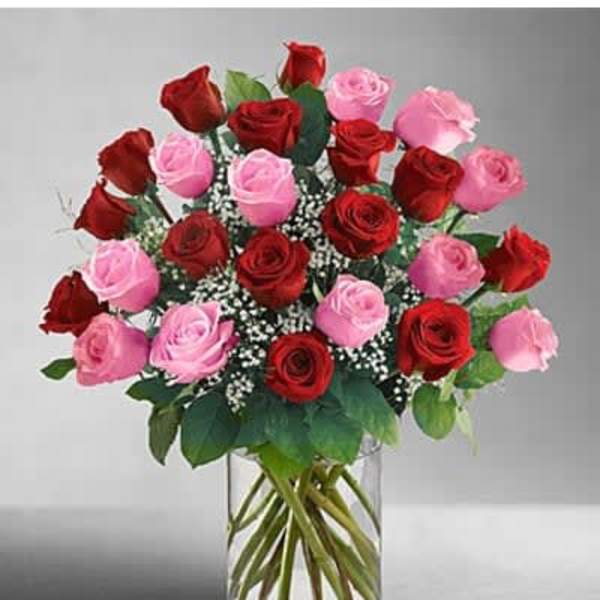 Bouquet of red and pink roses in a clear glass vase