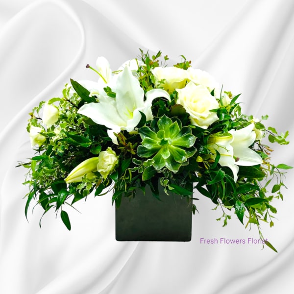 White lilies and roses in a black square vase