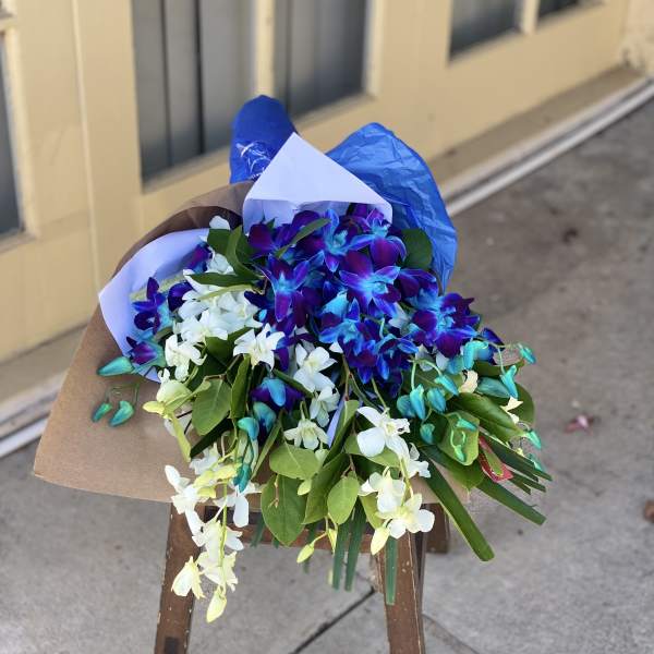 Bouquet of blue and white orchids wrapped in paper