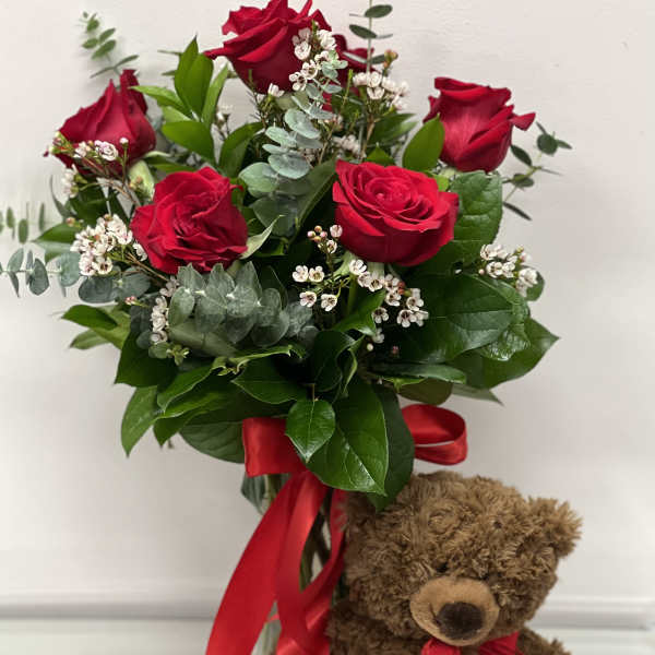 Red rose bouquet with a teddy bear and red ribbon