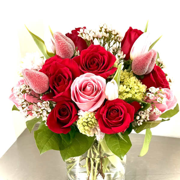 Bouquet of red and pink roses in a clear glass vase