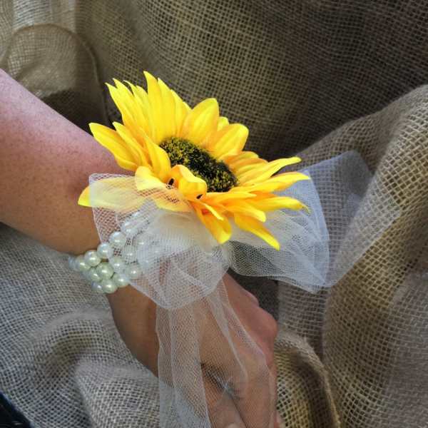 Yellow sunflower wrist corsage with white tulle and pearl bracelet