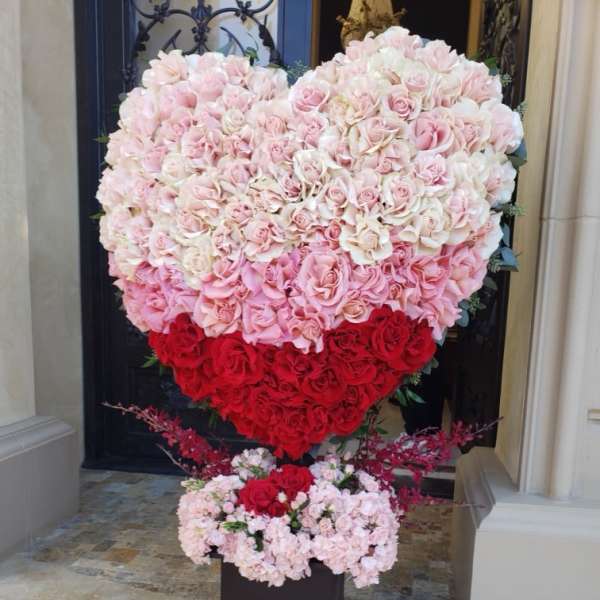 Heart-shaped rose arrangement in pink, white, and red