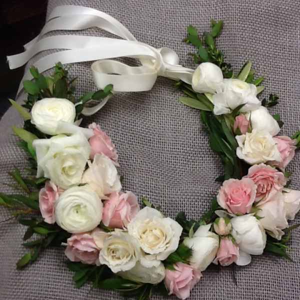 Floral wreath with white and pink roses tied with a white ribbon