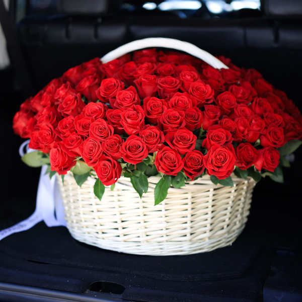 Basket of red roses with a white handle