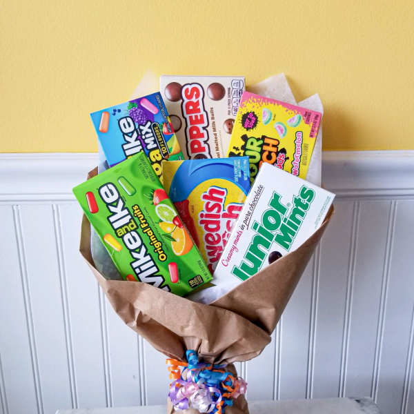 Bouquet of assorted candy boxes wrapped in brown paper