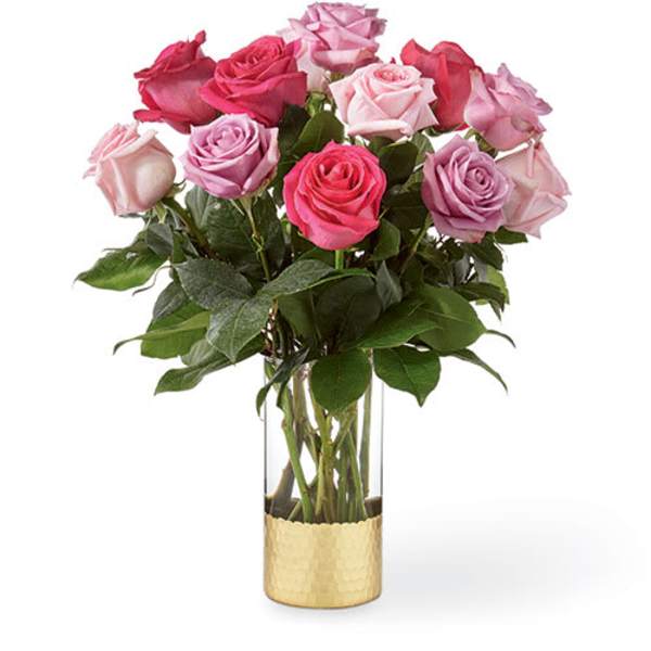 Bouquet of pink and lavender roses in a clear glass vase