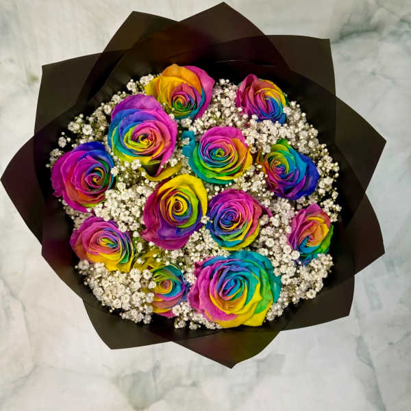 Bouquet of rainbow-colored roses with white filler flowers