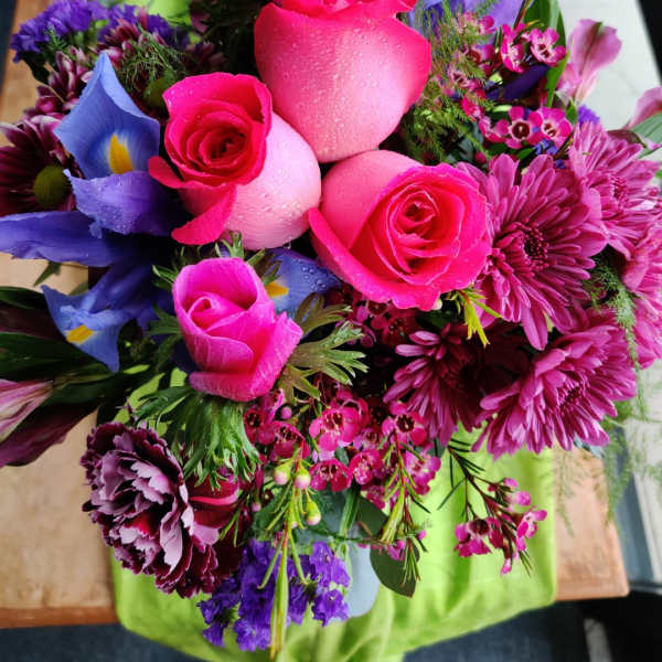 Bouquet of pink roses, purple blooms, and mixed flowers