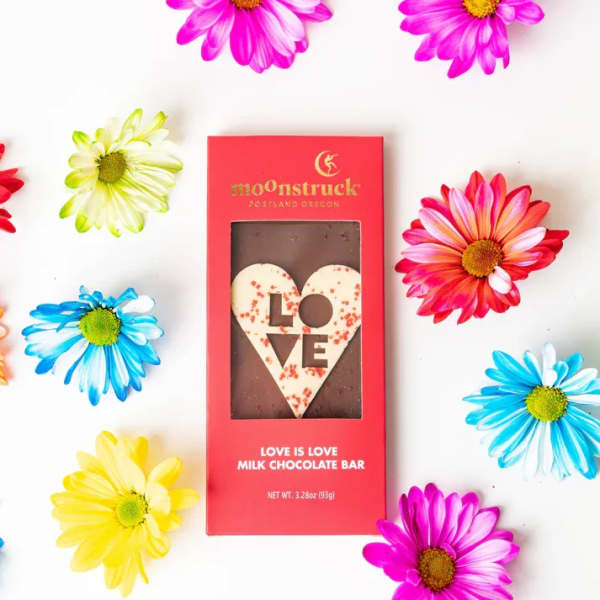 Red boxed chocolate bar with heart-shaped LOVE design surrounded by colorful daisies.