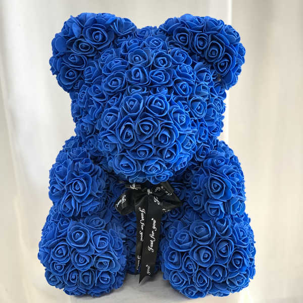 Blue teddy bear made of roses with a black ribbon