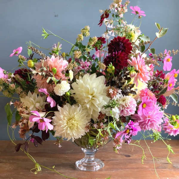 Large mixed flower arrangement in a clear glass vase