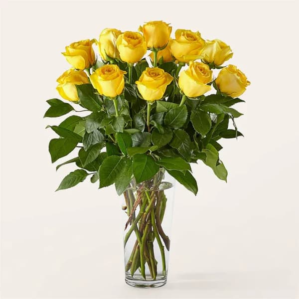 Yellow roses arranged in a clear glass vase
