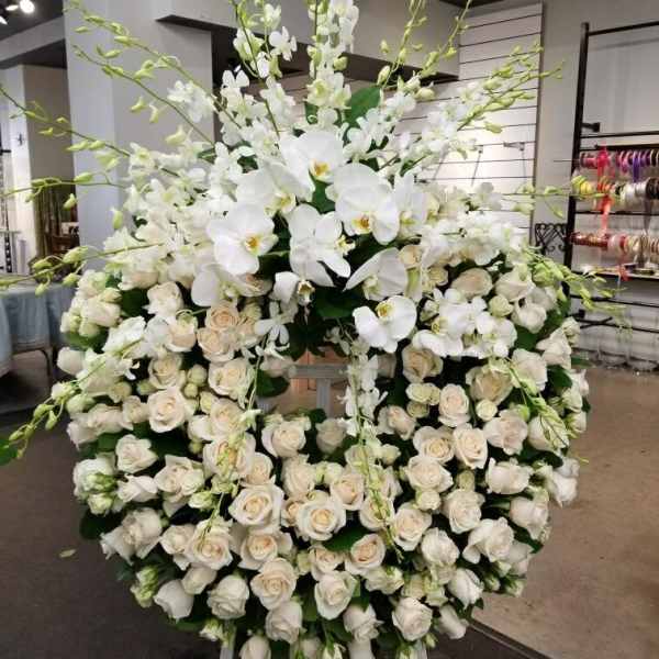 Large white floral standing spray with roses and orchids