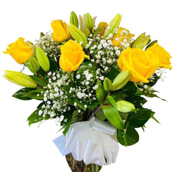 Yellow roses and lilies in a wrapped bouquet with baby's breath