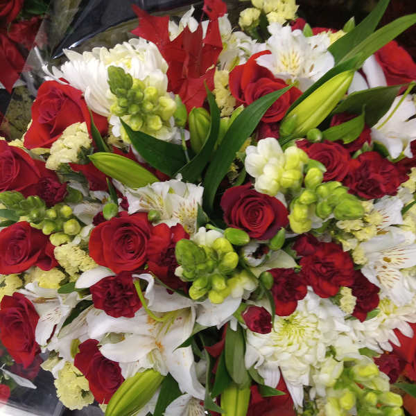 Bouquet of red roses, white lilies, and green snapdragons