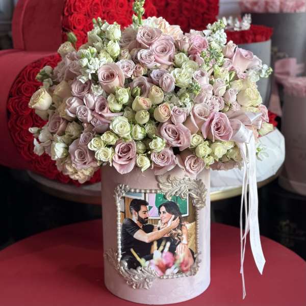 Pink and cream rose bouquet in a decorative hatbox with a framed photo
