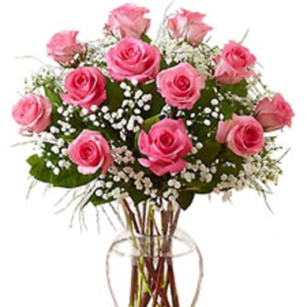 Pink roses arranged in a clear glass vase