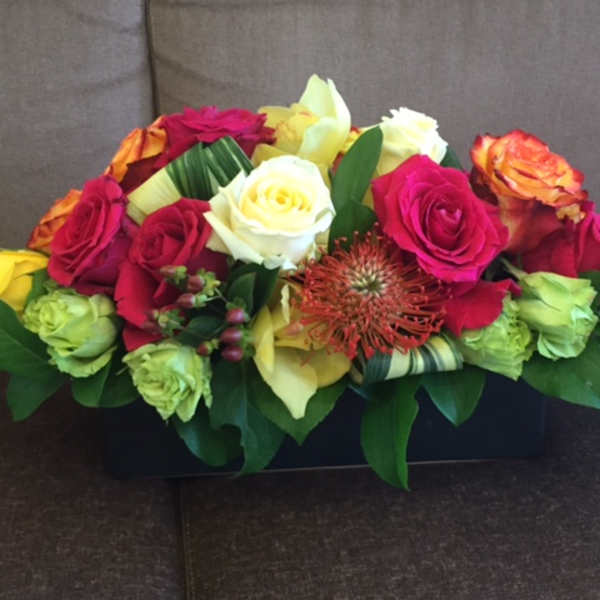 Mixed roses in a low rectangular arrangement
