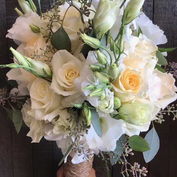 Bouquet of white roses and pale lisianthus with eucalyptus