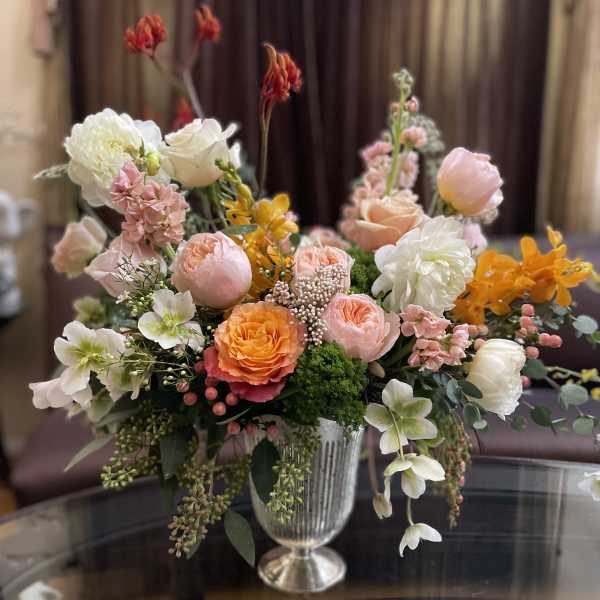 Mixed pastel flower arrangement in a silver vase
