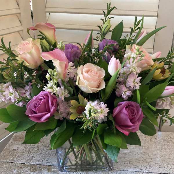 Mixed pink and purple bouquet in a clear glass vase