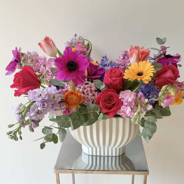 Colorful mixed bouquet in a white ribbed vase