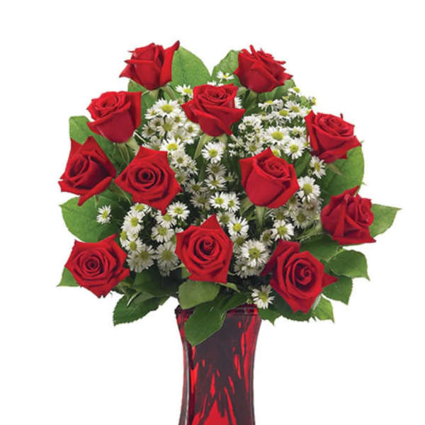 Red roses and white daisy-like flowers in a red glass vase