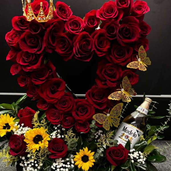 Heart-shaped red rose arrangement with sunflowers and a bottle of Modelo