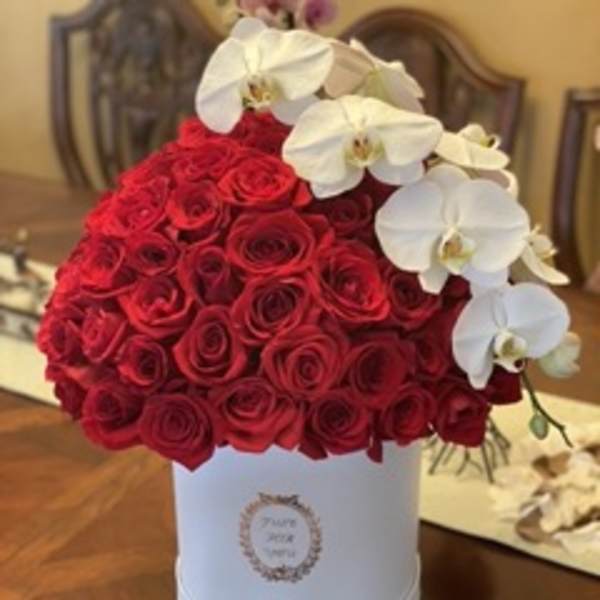 Red rose arrangement in a white hat box with white orchids