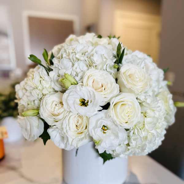 White rose and hydrangea bouquet in a white vase
