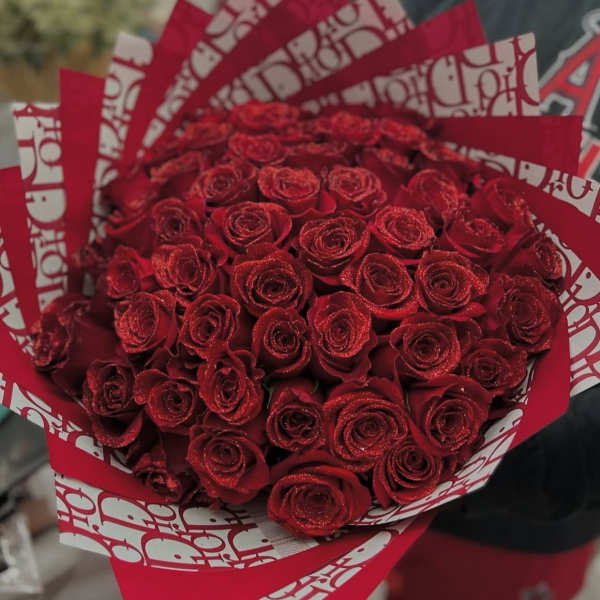 Bouquet of red roses wrapped in red and white paper