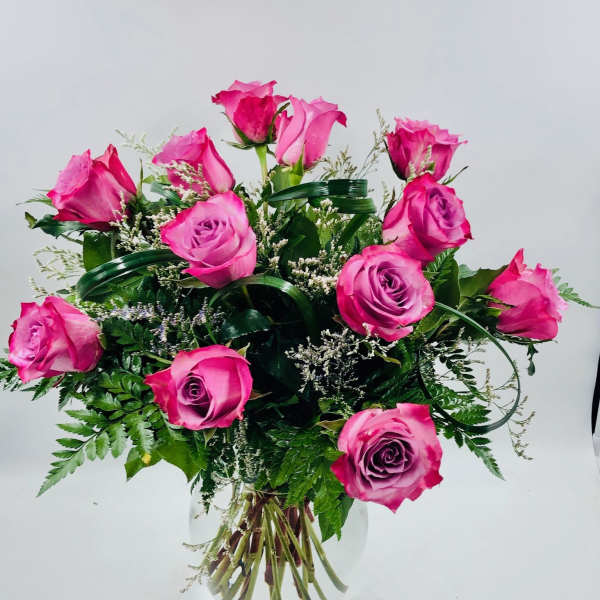 Pink roses arranged in a clear glass vase