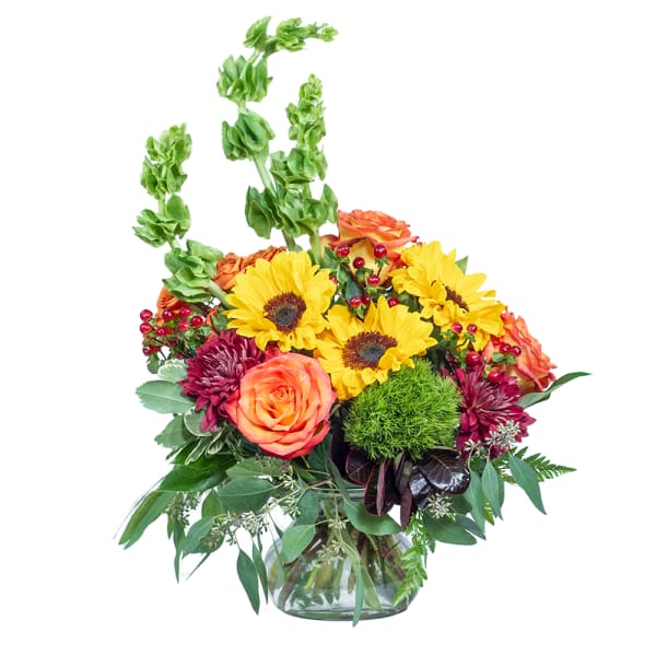 Bouquet of sunflowers, roses, and mums in a glass vase