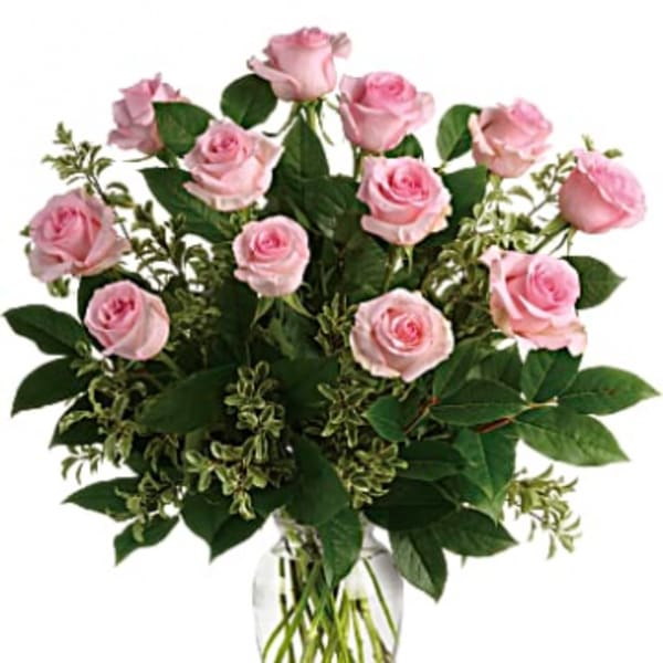 Arrangement of light pink roses in a clear glass vase