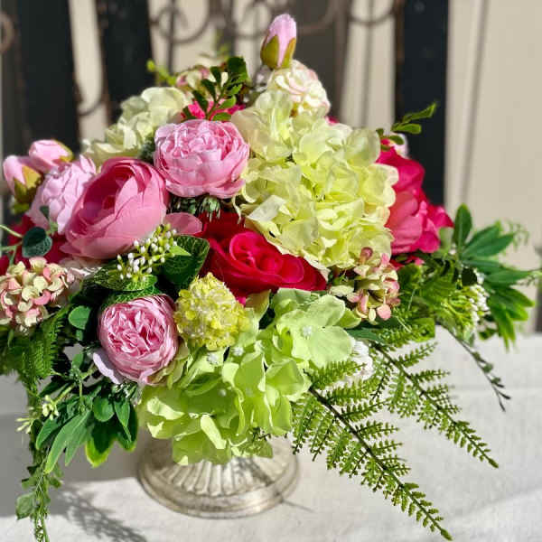 Pink and green floral arrangement in a clear glass vase