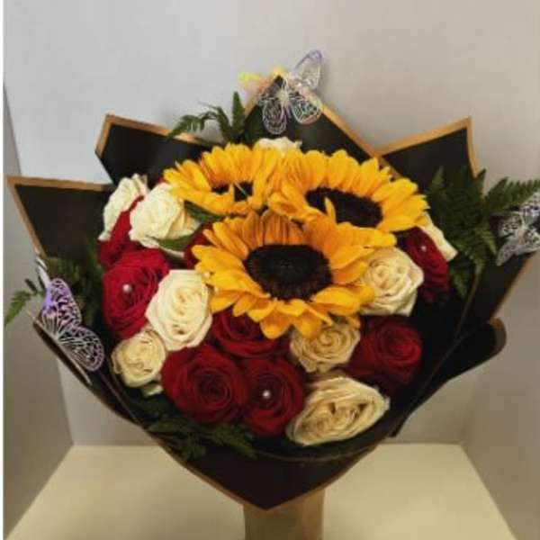 Bouquet of red and white roses with sunflowers in black wrap