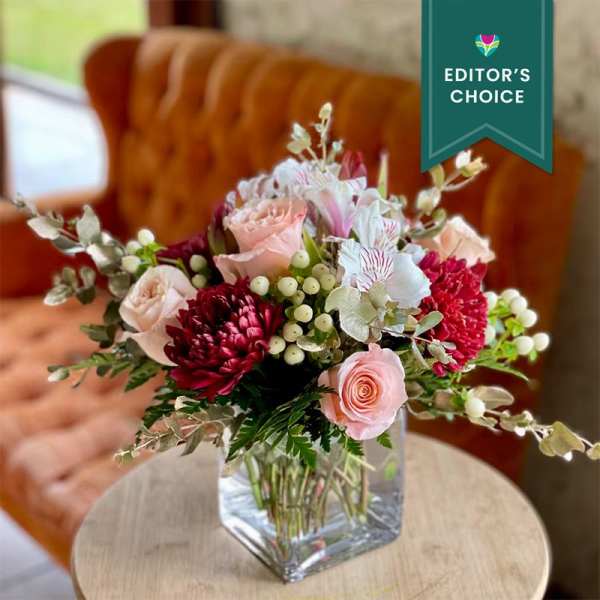 Pink and burgundy mixed bouquet in a clear glass vase