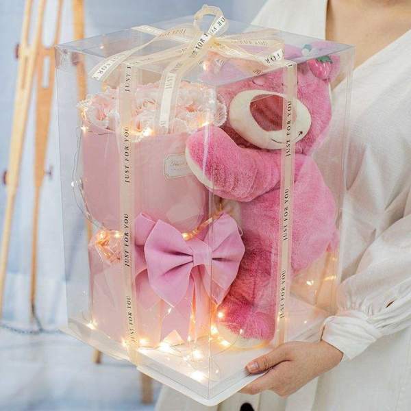 Pink teddy bear gift box with ribbon and lights