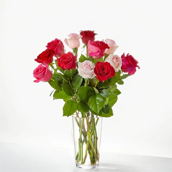Bouquet of red and pink roses in a clear glass vase