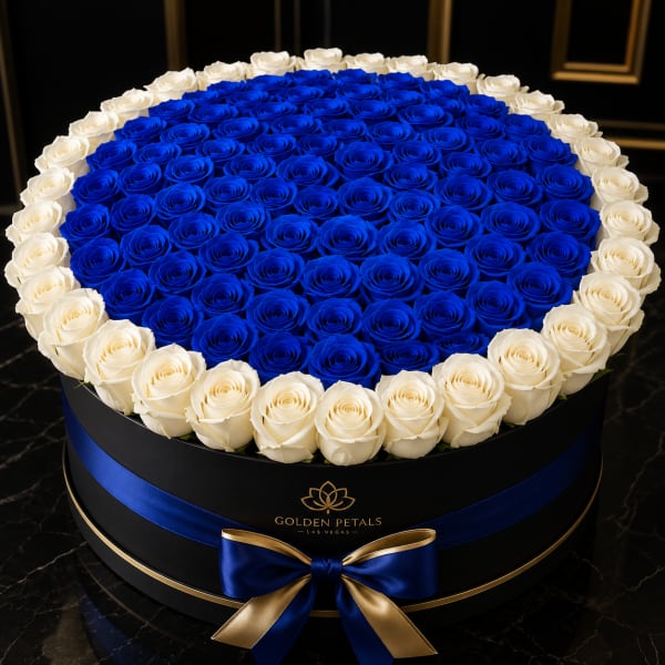 Round box of blue and white roses with a blue ribbon bow